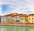 Embankment of The River Arno in The Italian City of Pisa. A bridge passes over the river and houses on both sides are overlooking Royalty Free Stock Photo