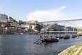 The embankment of river Douro, Porto, Portugal. Traditional Portuguese rabelo boats with wooden barrels of port on it. V Royalty Free Stock Photo