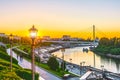 Embankment of the river with stairs and street lights at the summer sunset. Royalty Free Stock Photo