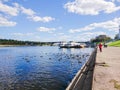 Embankment of the river Volga in Tver, Russia. Autumn Sunny day. Pleasure boats at the pier. Wild Mallard ducks swim in the river