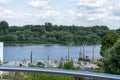 Embankment of the Vistula River in Warsaw. The ship is sailing. View of the bridge and the stadium. Sky with clouds.