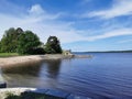 The embankment of the Vyborg Bay with a pier, stairs and a Tea gazebo at the top in the Monrepos Park of the city of Vyborg Royalty Free Stock Photo