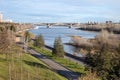 The embankment of the Yenisei River and the automobile-pedestrian communal bridge in the distance in the city. Royalty Free Stock Photo