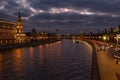 Embankments of Moskva river against Moscow Kremlin on a background of cloudy sky at evening. City landscape Royalty Free Stock Photo