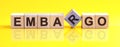 Embargo word is made of wooden building blocks lying on the yellow table Royalty Free Stock Photo