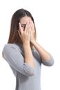 Embarrassed woman looking through her hands covering her face Royalty Free Stock Photo