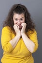 Embarrassed young big woman touching her face for wellness Royalty Free Stock Photo