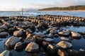 Embedded stones and harbor ruins in Narva-JÃÂµesuu. Rocky beach, peaceful sea and port.