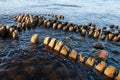 Embedded stones and harbor ruins in Narva-JÃÂµesuu. Rocky beach, peaceful sea and port.