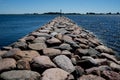 Embedded stones. Rocky beach, peaceful sea, harbor. Mole in Munalaid