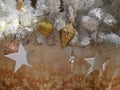 Embellished Christmas tree decoration gold ornament, hanging ball, silver star and tinsel Royalty Free Stock Photo