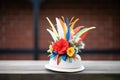 embellishing a derby with colorful feathers Royalty Free Stock Photo