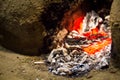 Embers of a dying fire in a wood fired stove made out of mud and Royalty Free Stock Photo