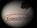 Embezzlement text circled in red pencil on dark background Royalty Free Stock Photo