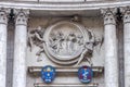 The emblem of the arms with stone sculptures as the pattern on the building with columns in Rome, Italy Royalty Free Stock Photo