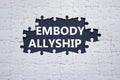 Embody Allyship symbol. Concept word Embody Allyship on white puzzle. Beautiful dark blue background. Business and Embody Allyship