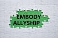 Embody Allyship symbol. Concept word Embody Allyship on white puzzle. Beautiful green background. Business and Embody Allyship