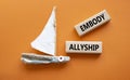Embody Allyship symbol. Concept word Embody Allyship on wooden blocks. Beautiful orange background with boat. Business and Embody