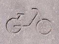 Embossed bicycle pictogram in concrete.