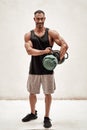 Embossed fitness couch posing in a studio with fitness gear