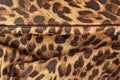 Embossed genuine leather, tropical pattern of leopard close-up, texture and fashionable trendy background Royalty Free Stock Photo