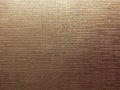 Embossed golden shiny metallic foil texture as background