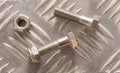 Embossed metal sheet with nuts and bolt