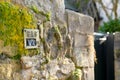 Embossed sign seen attached to an old stone wall, informing the location of a gas valve. Royalty Free Stock Photo