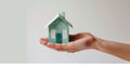 affordable housing dream: hand holding paper house on light background, Generative AI Royalty Free Stock Photo