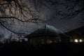 Old house with a Ghost in the forest at misty night or Night scene with House under moon. Old mystic building in dead tree forest Royalty Free Stock Photo