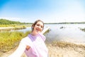 Lakeside Selfie Joy: Radiant Girl in Nature