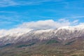 Snow-Kissed Majesty: Crisp Autumn Skies Over Mountain Peaks