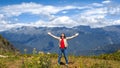 Embrace the world around, young woman in the mountains,