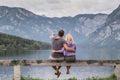 Embraced couple watching tranquil overcast morning scene at lake Bohinj, Alps mountains, Slovenia.