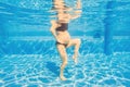 Embracing aquatic fitness, a pregnant woman demonstrates strength and serenity in underwater aerobics, creating a serene