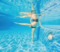 Embracing aquatic fitness, a pregnant woman demonstrates strength and serenity in underwater aerobics, creating a serene