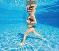 Embracing aquatic fitness, a pregnant woman demonstrates strength and serenity in underwater aerobics, creating a serene