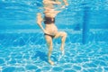 Embracing aquatic fitness, a pregnant woman demonstrates strength and serenity in underwater aerobics, creating a serene