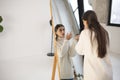 Embracing the Christmas spirit, a lovely young woman perfects her makeup at the mirror. Royalty Free Stock Photo