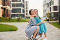 Embracing each other. Young mother with her little daughter walking near the buildings Royalty Free Stock Photo