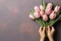 Embracing love. tender hands passing gift and bouquet of tulips with delicate tones