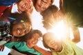 Embracing our differences. Portrait of a group of diverse and happy kids huddled together on a bright day outside. Royalty Free Stock Photo