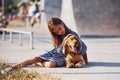 Embracing the pet. Cute little girl have a walk with her dog outdoors at sunny day Royalty Free Stock Photo