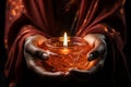 Embracing the shadows, hands offer solace with a glowing candle Royalty Free Stock Photo