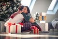 Embracing couple for Christmas.Girl surprise her boyfriend