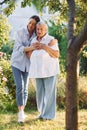 Embracing and smiling. Young woman is with her senior mother is in the garden Royalty Free Stock Photo