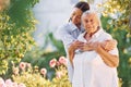 Embracing and smiling. Young woman is with her senior mother is in the garden Royalty Free Stock Photo