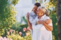 Embracing and smiling. Young woman is with her senior mother is in the garden Royalty Free Stock Photo