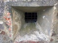 The embrasure of the old castle is barred with an iron grate Royalty Free Stock Photo