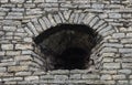 Embrasure in old gray stone wall Royalty Free Stock Photo